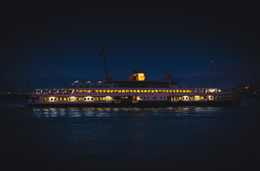 Fototapeta na wymiar Istanbul City Ferry Sailing During Twilight With the Background of Hagia Shophia