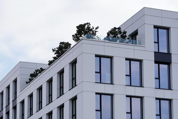The Modern apartment building is with plants. Parts of the house with landscaping, the introduction of plants in concrete buildings. Modern residential areas in European city