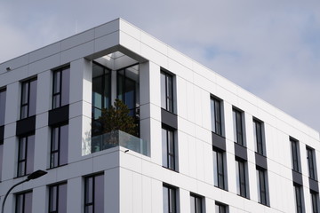 The Modern apartment building is with plants. Parts of the house with landscaping, the introduction...