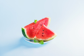 Watermelon slice on light blue background. Summer concept
