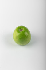 A green apple on white backdrop