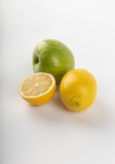 Lemon and a green apple on white background