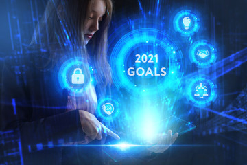 Business, Technology, Internet and network concept. Young businessman working on a virtual screen of the future and sees the inscription: 2021 goals