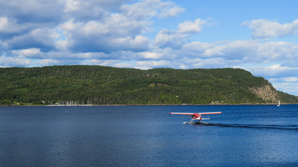 Fototapeta na wymiar La Baie, Canada - september 2019 : Seaplane landing on the Saguenay river 
