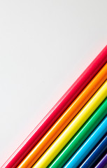 Colored pencils arranged in diagonal pattern on white background