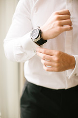 Obraz na płótnie Canvas Groom's wristwatch and cufflinks. Suit.