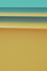 pastel ,soft two tone color of yellow and blue,  paper in layer as fashion background, flat lay