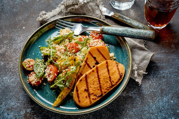 Slices of fresh barbecued sweet potato with salad