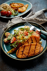 Grilled or barbecued fresh sweet potato slices