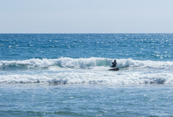 A man kitsurfing in the ocean in a beautiful sunny day