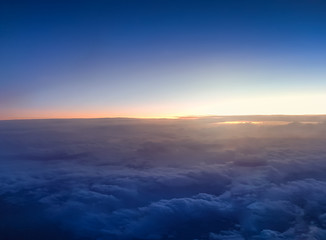 Fototapeta na wymiar Amazing view of the sunrise over the clouds at dark night sky