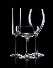 Set of different empty glasses for drinks on black background