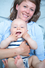 Cute baby with mother at home