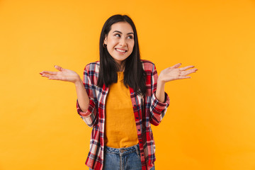 Photo of pleased young woman smiling and holding copyspace