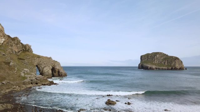 Coastal shot of San Juan de Gaztelugatxe where the rough seas and huge cliffs surround the scenery.