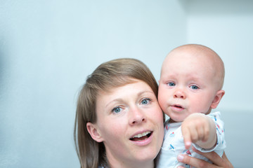 Cute baby with mother at home