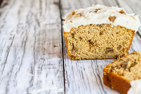 Keto "Carrot" Cake without the carrots to truly stay in ketosis for Easter. Loaf is baked with almond flour and walnuts and frosted with a sugar free cream cheese frosting. Blurred Background.