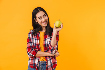 Photo of happy young woman smiling and holding apple