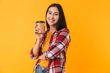 Photo of happy young woman smiling and drinking coffee takeaway