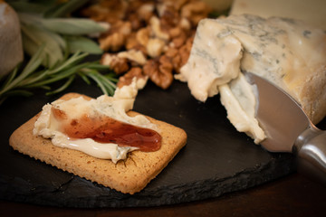 Bleu cheese and raspberry chili preserve on cracker