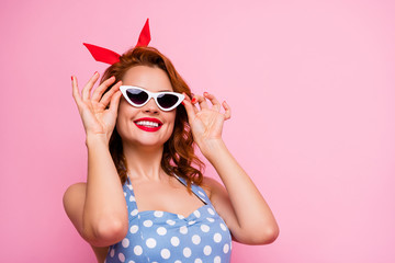 Closeup photo of charming funny lady summer vacation holding hands on cool white stylish sun specs toothy smiling wear headband dotted dress isolated pink color background