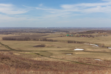 Obraz premium Early spring landscape in a field near the forest, russia, selective focus