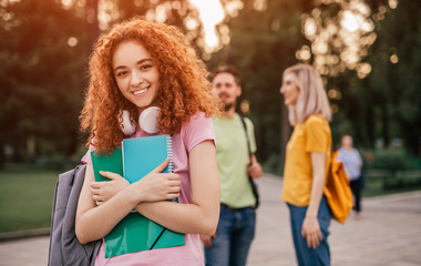 Cheerful female student in park