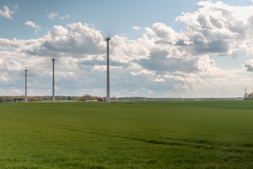 Wind power station - wind turbine against the cloudy sky. Spring Central Sweden. selective focus