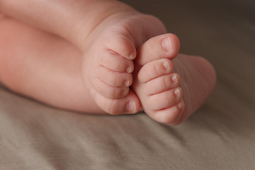 Close up of the tiny legs of a sleeping baby