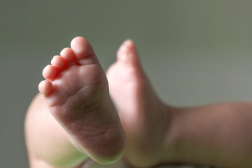 Close up of the tiny legs of a lying baby