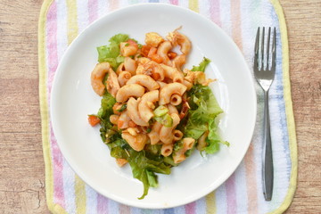stir fried macaroni with chicken and egg dressing ketchup on plate