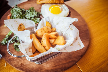 Fried egg and salad. Egg salad sandwich with French fries. The salad with homemade baked French...