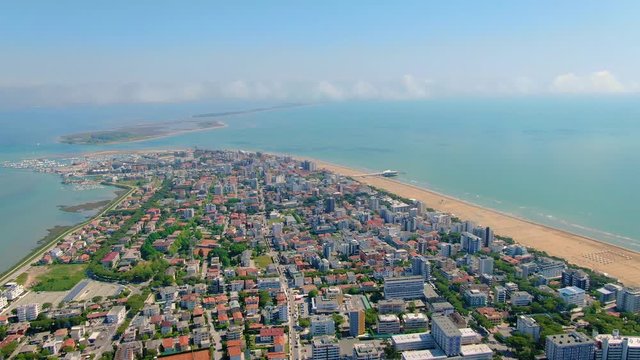 City on the small Italian peninsula Lignano, surrounded by the clear waters of the Adriatic sea and Marano Lagoon. A small island in the distance