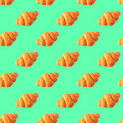 Seamless croissant pattern on mint background.