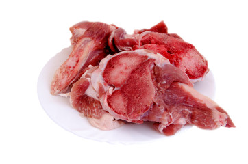 Raw meat on bones in a plate