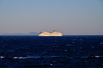 Modern Costa Cruises cruiseship or cruise ship liner at sea with blue ocean and coast line of Spain...