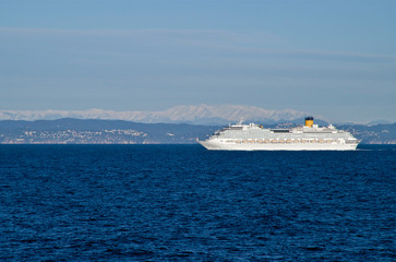 Modern Costa Cruises cruiseship or cruise ship liner at sea with blue ocean and coast line of Spain...