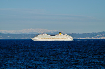 Modern Costa Cruises cruiseship or cruise ship liner at sea with blue ocean and coast line of Spain...
