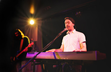 Pianist playing on electric piano at a show