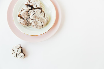 chocolate cookies on the pink plate.white minimalistic background.top view