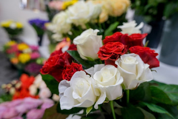 Bouquet with red and white roses. Close up of flowers..Beautiful floral background. Concept of holiday, presents, flower shop.
