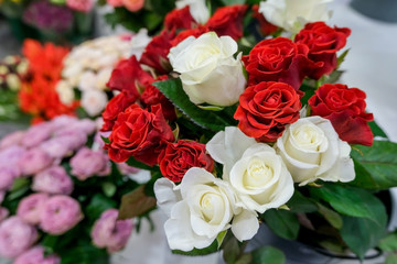 Bouquet with red and white roses. Close up of flowers..Beautiful floral background. Concept of holiday, presents, flower shop.