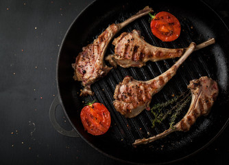 Grilled lamb ribs with spices in a frying pan