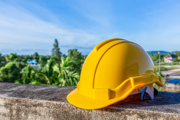 Yellow safety helmet on concrete