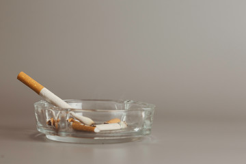 Cigarette in ashtray is addictive to be cancer.smoking reduction campaign in World No Tobacco Day.