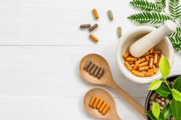 Herbal supplement in capsules with healthy medicinal plant.Alternative drug or natural pharmaceutical capsule.Medication of vitamin supplemental for care and treatment.Top view.