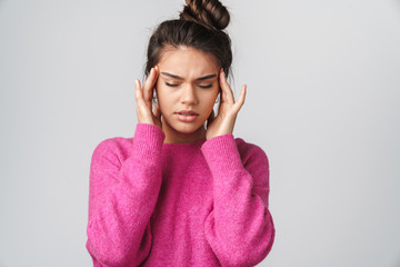 Image of nice unhappy woman with headache rubbing her temples