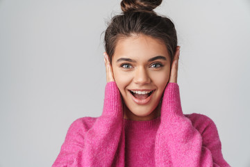 Image of nice excited woman smiling and covering her ears