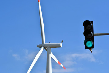 wind turbine and a traffic light that is on green