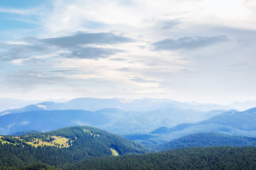 Fototapeta premium Beautiful mountain landscape. Distant mountains under a blanket of clouds_